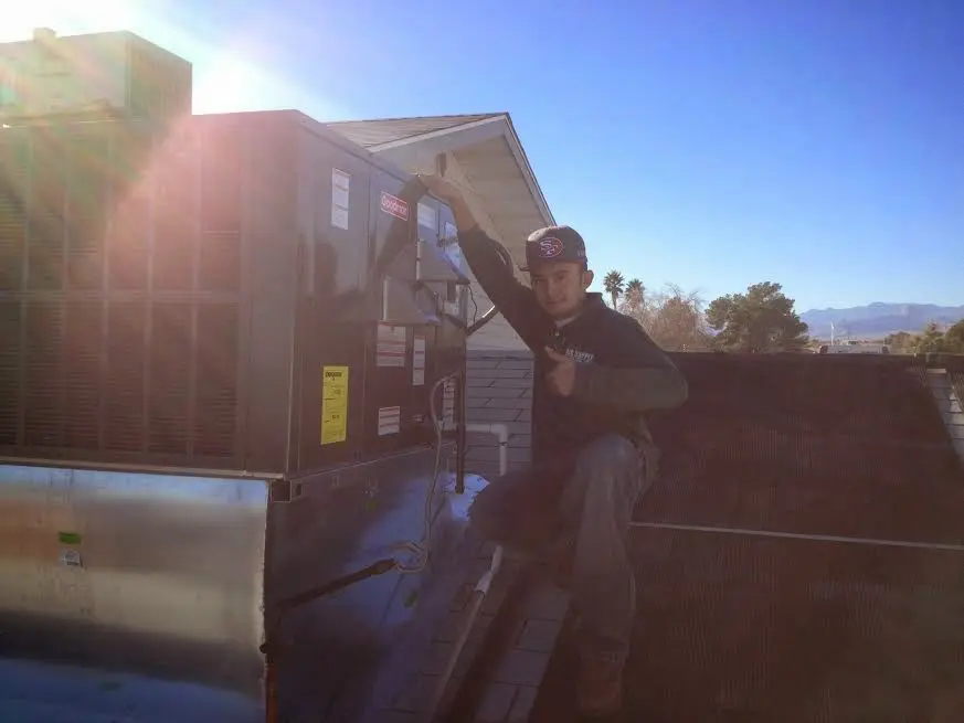 HVAC technician performing Boiler Repair on a rooftop unit in Murphy
